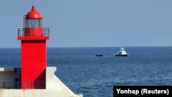 一艘韩国军舰拖着一只据信是逃出朝鲜的脱北者乘坐的小木船前往韩国襄阳港口。(2023年10月24日)