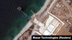 资料照片:Maxar Technologies卫星图像显示美军运作的加沙人道主义救援码头在移开之前的状态。(2024年6月12日)