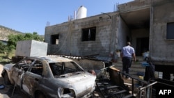 西岸地区拉姆安拉市附近一个村庄遭到以色列定居者的攻击,住房被毁。(2024年4月13日)