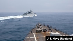 资料照:从美国海军钟云号伯克级导弹驱逐舰的甲板上可以看到中国海军旅洋III号导弹驱逐舰在台湾海峡附近驶过。 (2023年6月3日)