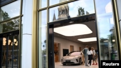 德国柏林居民正在一个中国蔚来汽车展厅里观看展示的NIO电动车。（2023年8月17日）