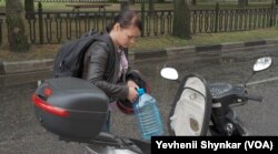 乌克兰尼科波尔居民梅拉妮娅骑车在全城各处寻水,她试着不去想什么核灾难的忧心事。