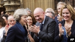 2016年7月11日,英国内务大臣特里萨·梅在英国国会外面受到保守党国会议员们的欢迎。