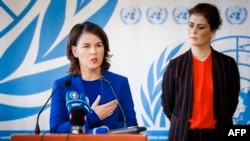 在联合国人权理事会在联合国日内瓦总部就伊朗局势召开特别会议期间,德国外长贝尔伯克与冰岛外长吉尔法多蒂尔站在一起,回答记者提问。(2022年11月24日)