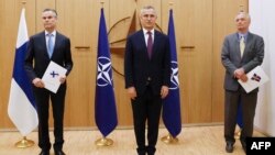 北约秘书长斯托尔滕贝格（中）与芬兰驻北约大使科尔霍宁（左）和瑞典驻北约大使韦恩霍夫（右）在布鲁塞尔出席两国加入北约的申请仪式。（2022年5月18日）