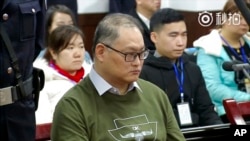  这张照片来自于2017年11月28日发布的一段视频，当时在湖南省岳阳市岳阳市中级人民法院，台湾人权活动人士李明哲在法庭受审。