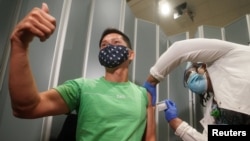 纽约市西奈山医院的Tommy Wong医生在接种辉瑞新冠病毒疫苗时伸出大拇指。(2020年12月15日)