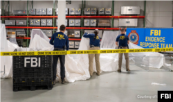 美国联邦调查局提供的图片显示调查局特工在检验美国海军在南卡罗莱纳州海岸外打捞出来的被击落的中国间谍气球碎片。(2023年2月7日)