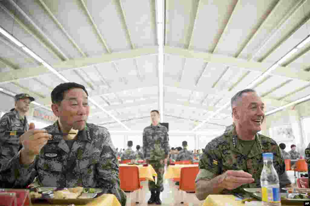 美军参联会主席邓福德上将(右)与中国北部战区司令员宋普选在北部战区陆军某合成旅同军人们共进午餐 (2017年8月16日)。邓福德将军前往中国东北沈阳市,观察人民解放军北部战区司令部的演习。 北部战区司令部距中朝边界约200公里。