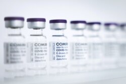 FILE - Empty vials to be filled with the Pfizer/BioNTech vaccine are seen at a production facility in Reinbek, near Hamburg, Germany, April 30, 2021.
