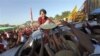 Supporters of India&#39;s main opposition wave at their candidate, Narendra Modi, as he arrives to file his election nomination papers in Varanasi.