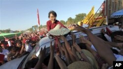 Supporters of India's main opposition wave at their candidate, Narendra Modi, as he arrives to file his election nomination papers in Varanasi.