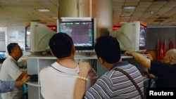 A jaguar (Panthera onca) hunts a fish as it swims in its enclosure at Pessac Zoo on the outskirts of Bordeaux, France.