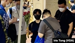 有市民6月4日晚帶鮮花到铜锣湾悼念六四被便衣警察截查。(美国之音/汤惠芸)