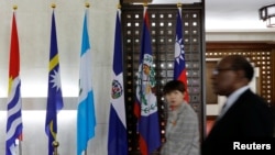 An emergency paramedic leans against a wall outside the Matei Bals hospital compound in Bucharest, Romania, where an early-morning fire killed four people, authorities said.