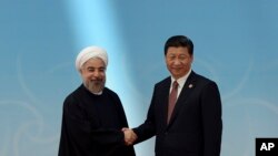 2014年5月21日,习近平在上海与出席亚信峰会的伊朗总统鲁哈尼握手