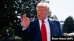 美国总统特朗普在白宫南草坪上对记者们发表讲话。此时,特朗普正准备离开华盛顿,前往他在新泽西的高尔夫俱乐部度假(2019年8月9日)。