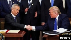 中国副总理刘鹤2020年1月15日在白宫与美国总统特朗普签署第一阶段美中贸易协议(路透社)。