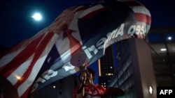 在2020年6月20日奥克拉荷马州的塔尔萨市造势活动的前夜,特朗普总统的支持者在高呼“美国”。