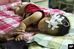 一名因食用毒奶粉而患病住院接受治疗的儿童(资料照片)