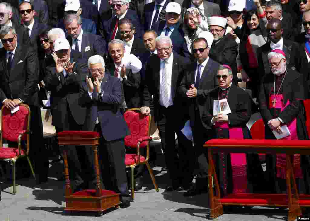 Palestinian President Mahmoud Abbas (front row, on L) applauds during a ceremony for the canonization of four nuns at Saint Peter's square in the Vatican City, May 17, 2015.