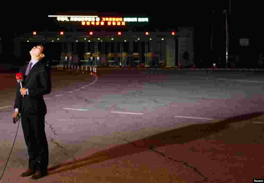 2013年4月29日,一名电视记者站在空空荡荡的韩国坡州海关移民与建议办事处的大门前准备做报道。