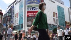 日本民众在东京港区新桥车站附近行走。(2021年7月29日)