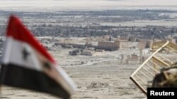 叙利亚国旗飘扬在叙利亚中部古城帕尔米拉的废墟附近(2016年4月1日)