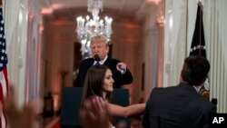 特朗普总统与CNN记者阿科斯塔在记者会上言辞交锋,一名白宫实习生试图从阿科斯塔手中拿走麦克风。(2018年11月7日)