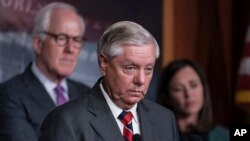 资料照片:南卡罗来纳州共和党参议员林赛·格雷厄姆(中),2023 年 12 月 7 日星期四在华盛顿国会大厦。 (美联社图片)