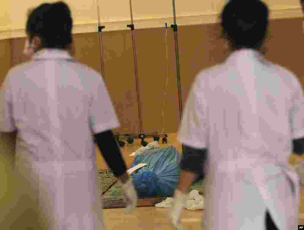 The remains of one of the victims of the Lao Airlines plane crash lies in a Chinese temple in Pakse, Laos Oct. 17, 2013. 