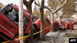 11月22日,青岛输油管爆炸后,受损的车辆倒在一条街上