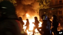 德国汉堡反G20峰会抗议火光中警察的侧影 (2017年7月6日)