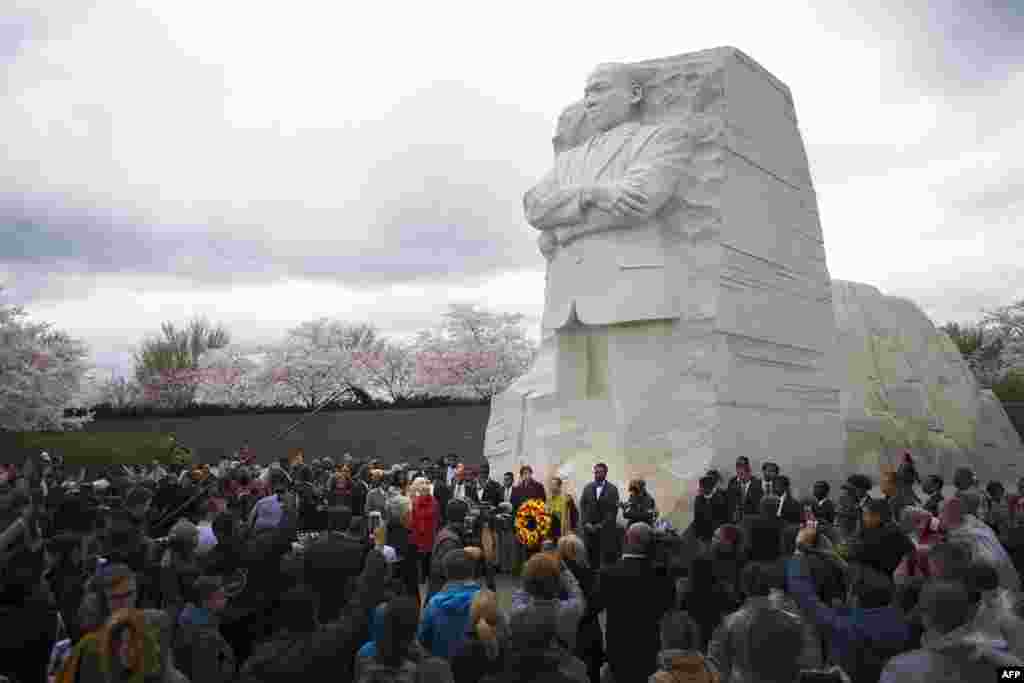 2018年4月4日，华盛顿特区，马丁&middot;路德&middot;金纪念园， 一座高9米的马丁路德金雕像之下，人们集会纪念Martin Luther King Jr.牧师遇刺50周年。时值樱花季节。马丁路德金雕像由中国雕刻家雷宜锌制作， 这是中国人首次完成如此重要的美国领袖人物的大型雕塑作品。 雕像上，马丁.路德.金从巨石中出现，表情凝重，双臂交叉，左手紧握文稿。