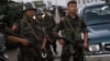 Soldiers from the Kachin Independence Army (KIA) stand on a road as they provide security in Laiza, a border town of China and Myanmar, Kachin State, Myanmar, Monday, Oct. 28, 2013. From 1961 until 1994, the KIA fought a grueling and inconclusive war against the Burmese junta fo