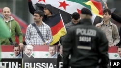 In this image from video provided by WBZ TV, spectators and runners run from what was described as twin explosions that shook the finish line of the Boston Marathon, April 15, 2013.