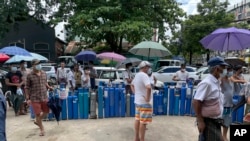 缅甸仰光居民排队等候给氧气管充气以救治新冠病人。(2021年7月11日)