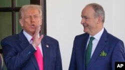 Ireland's Prime Minister Micheal Martin is greeted by President Donald Trump as he arrives at the West Wing of the White House in Washington, March 12, 2025.