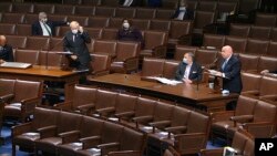 In this image from video, Rep. Kevin Brady, R-Texas., recognizes Rep. Steve Chabot, R-Ohio, left, to speak on the floor of the House of Representatives at the U.S. Capitol in Washington, April 23, 2020.