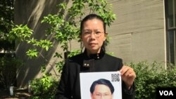 遭中国拘禁台湾人权工作者李明哲之妻李净瑜抱着李明哲像 (2017年5月17日,美国之音钟辰芳拍摄)