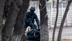 An armed riot police officer detains a protester after clashes in Almaty, Kazakhstan, Jan. 8, 2022.