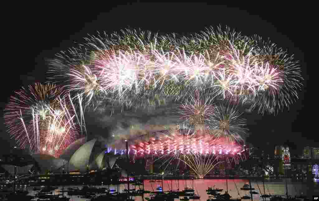 Fireworks explode over the Opera House and Harbour Bridge during New Year's Eve fireworks display in Sydney, Australian, Jan. 1, 2016.