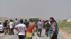 Displaced families from the minority Yazidi religious group, fleeing the violence, are seen on the outskirts of Sinjar, west of Mosul, Iraq, August 5, 2014.