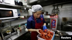 北京一家餐馆厨工用进口美国龙虾准备午餐(路透社2018年7月5日)