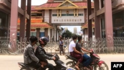 2021年7月5日,驾车者通过掸邦木姐镇的中缅边境大门,彼时靠近缅甸边境的中国城市瑞丽实施了封城并开始大规模新冠病毒测试。(法新社照片)