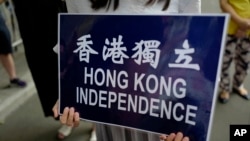 在香港警察总部前抗议的民众手持香港独立的标语。(2018年9月25日)