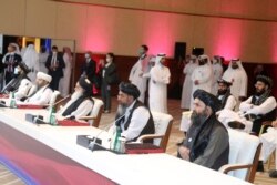 Members of the Taliban delegation attend the opening session of peace talks between the Afghan government and the Taliban, in Doha, Qatar, Sept. 12, 2020.