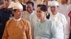 Myanmar's State Counselor Aung San Suu Kyi (R) accompanies new President Win Myint (L) to take his oath of office at parliament in Naypyidaw, March 30, 2018.