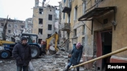 乌克兰克拉马托尔斯克的居民行走在被俄罗斯导弹摧毁的居民楼附近。(2023年2月2日)