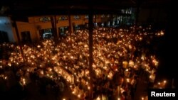 Tư liệu - Giáo dân thắp nến cầu nguyện trong phiên xét xử hai nhà hoạt động Nguyễn Hữu Vinh và Cấn Thị Thêu tại Nhà thời Thái Hà ở Hà Nội, Việt Nam, ngày 18 tháng 9, 2016.